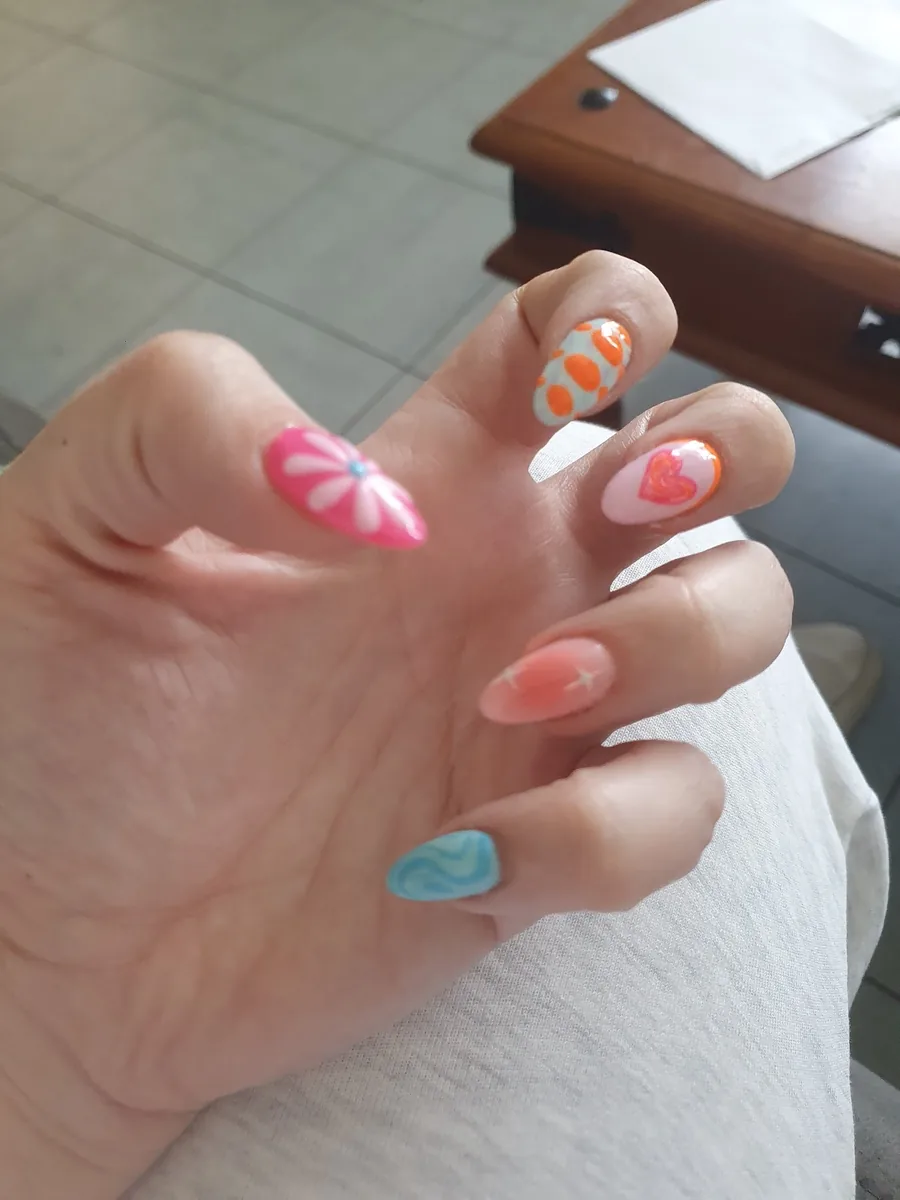 Long coffin nails in a mixed summer set with stripes, swirls and a blue tip